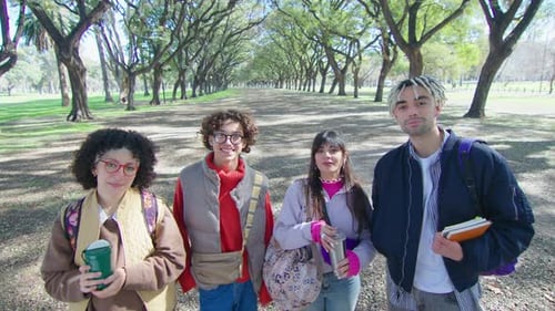 Cheerful College Students Posing on Camera in the Park