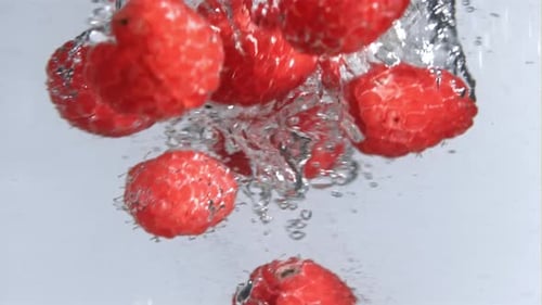 Fresh Raspberries Fall Into the Whirlpool