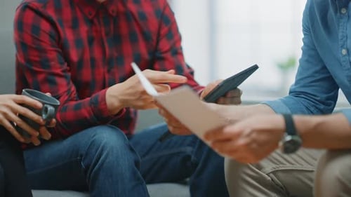 Business Team Discussing Work Project on Tablet