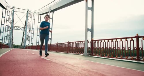 Woman Jogging on Bridge for Fitness