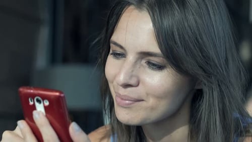Young Woman Texting in Modern Cafe