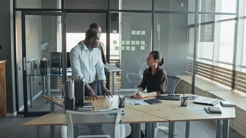 Team Discussing Business in Modern Office