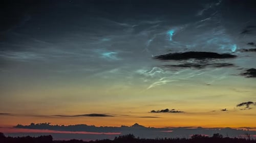 View of noctilucent clouds movement in timelapse. Beautiful mystic clouds at summer night.