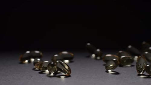 Close Up of Vitamin Capsules Dropping