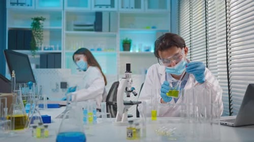 Asian male and female scientists work together in the research laboratory.