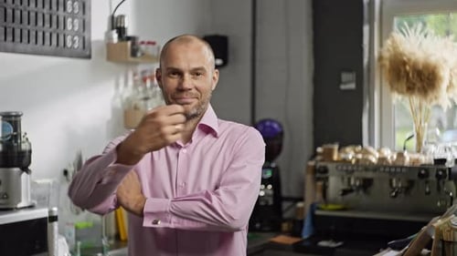 Portrait of a Professional Barista in a Cafe Who Folds His Hands and Smiles