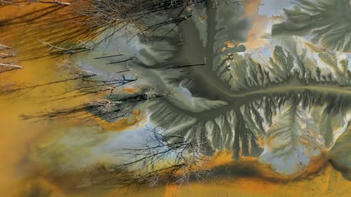 Aerial view of copper mining residuals flowing into decanting lake