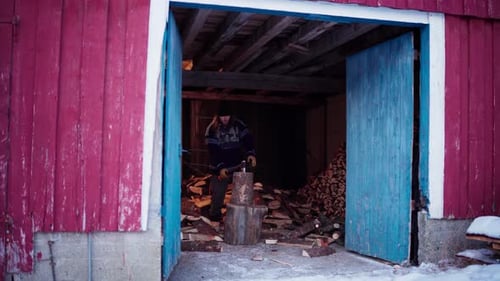 A Man is Using an Axe to Chop Firewood in Indre Fosen, Trondelag County, Norway - Static Shot