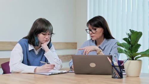 College Student Girl Sitting with Female Teacher Studying Individually in Class