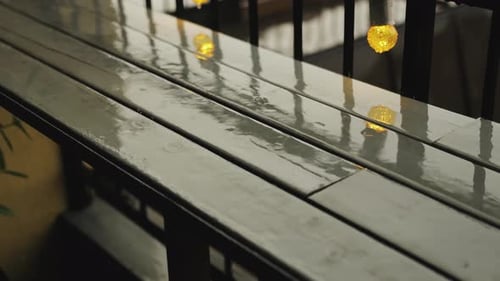 Raindrops Fall on a Wooden Surface Reflections of Raindrops on a Wooden Table on a Cafe Terrace on a