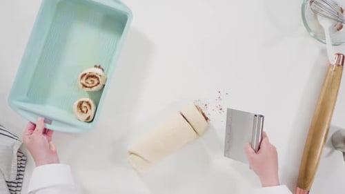 Flat Lay Unbaked Cinnamon Rolls in a Blue Baking Pan