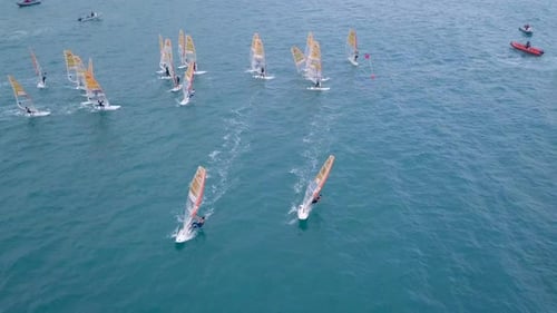 Aerial footage of High speed wind surfers riding the mediterranean waves