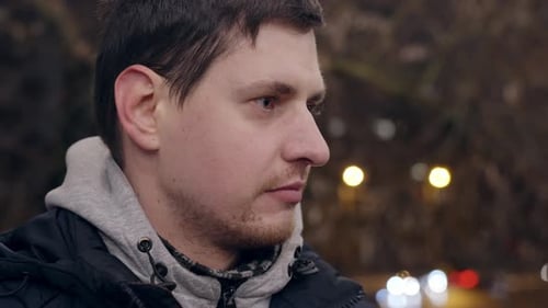 Sad and depressed young adult in closeup handheld view