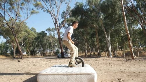 Young Adult Skillfully Riding a Unicycle Outdoors