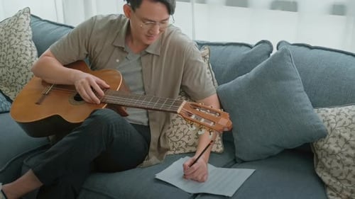 A musician is writing song in home Studio