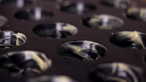 Close up focus pull of Muffin pan smeared with butter