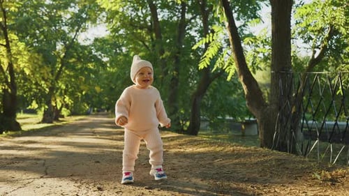 Toddler Enjoys Sunny Stroll Through Lush Green Park in the Afternoon Light