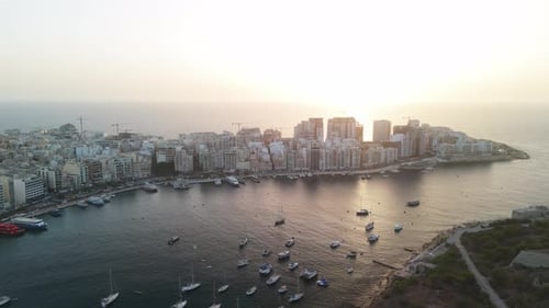 Sunrise drone flying over the harbour of Sliema and Valletta in Malta