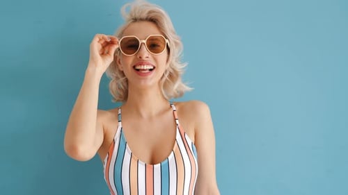 Smiling Young Woman Posing with Sunglasses