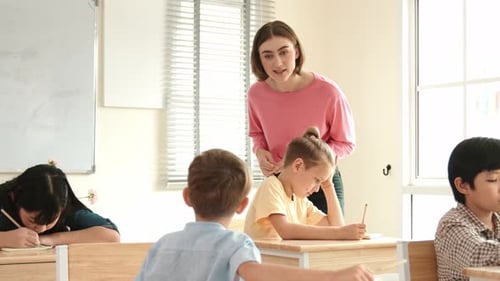 Teacher Explains Lesson to Students in Classroom