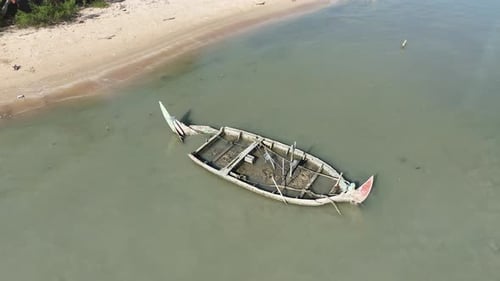 Old Fishing Boat Wreck Floating near the Shore from Aerial View