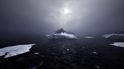 Nighttime Arctic Seascape Showing Scattered Ice and Faint Starlight Shimmering