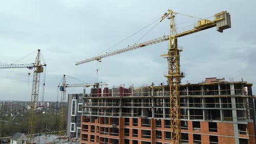 Tower Cranes and Frame Structure of High Residential Apartment Buildings at Construction Site