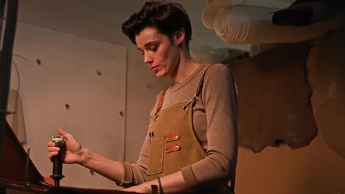 Young Female Artisan Crafting Leather Details Using Cutting Machine in Workshop