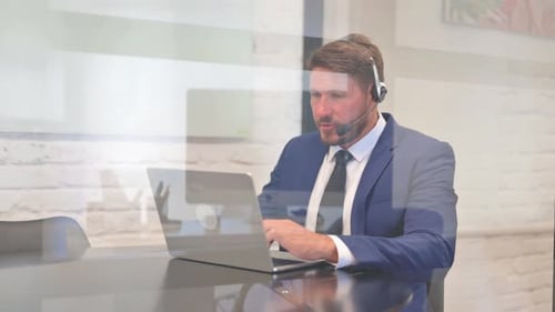 Man in Suit Working on Laptop in Office