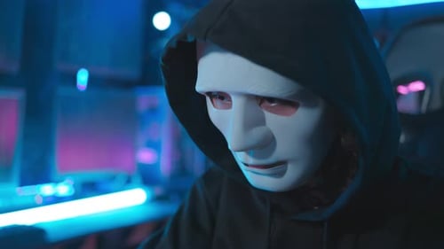 Close-up face hacker With a mask executing digital espionage