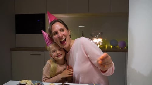 Mother and Daughter Celebrate Birthday with Sparkler