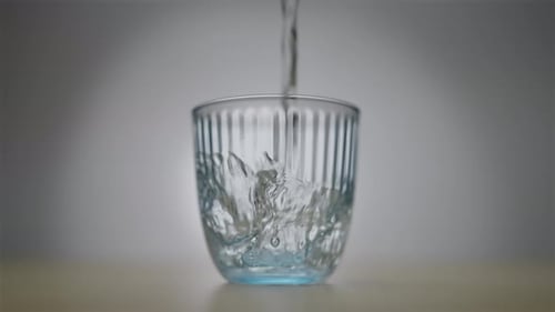 Water Being Poured into Glass Cup