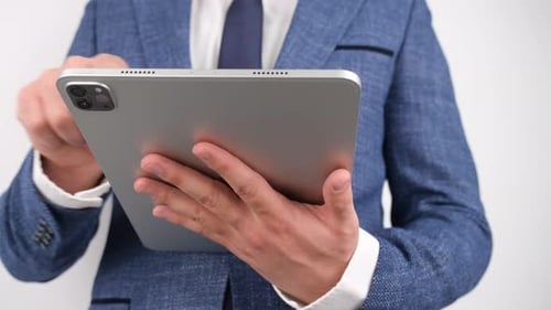 Adult Operating Tablet Device Wearing Dark Blue Suit