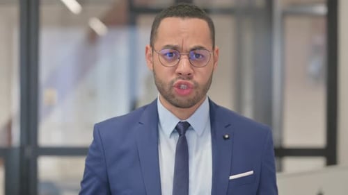 Portrait of Unsatisfied Mixed Race Businessman Fighting in Argument