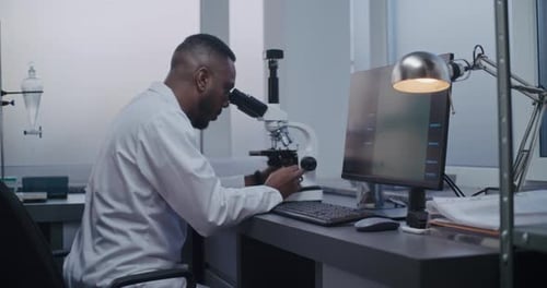 Scientist Using Microscope in Modern Laboratory