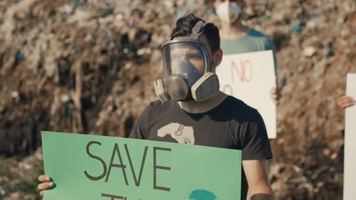 Group of People Protesting at Landfill with Signs