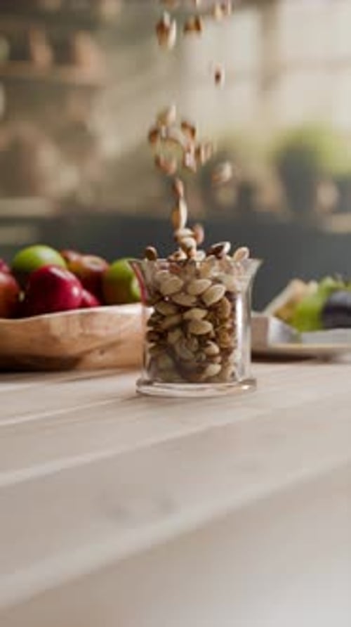 Healthy Pistachios Falling and Filling Clear Glass