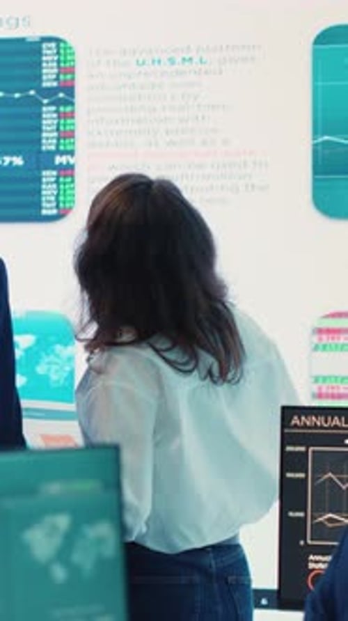 Businesswoman Leads Stock Data Presentation in Office