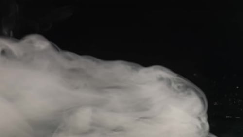 Billowing White Smoke Against Black Backdrop