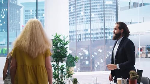 Portrait of Cheerful Financial Advisor in Office Meeting with Clients