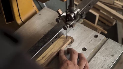 Close shot of a machine that is cutting small piece of wood