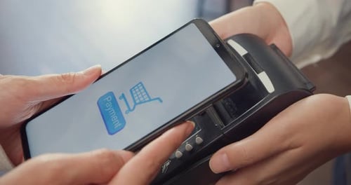 female self service use mobile phone pay contactless with credit card reader machine at cafe.