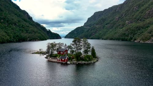 Discover the Serene Beauty of Lovrafjorden in Norway with Its Picturesque Red Cabin