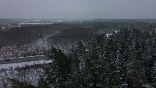 Breathtaking Aerial Perspective of Frostcovered Trees and Tranquil Icy River Bend During Winter
