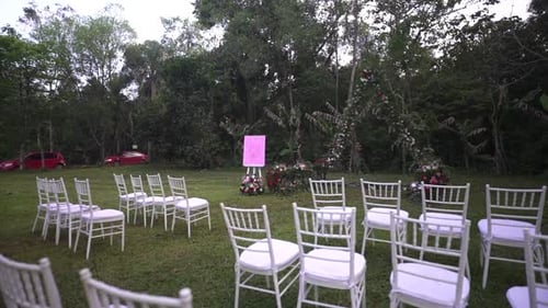 Empty White Chairs set for Outdoor Wedding Ceremony