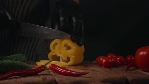 Chef Slices Bell Pepper on Cutting Board