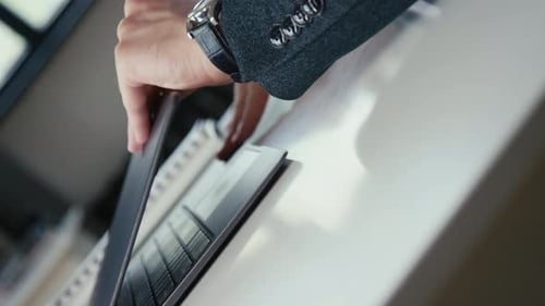 Well-Groomed Adult Opening Laptop in Office