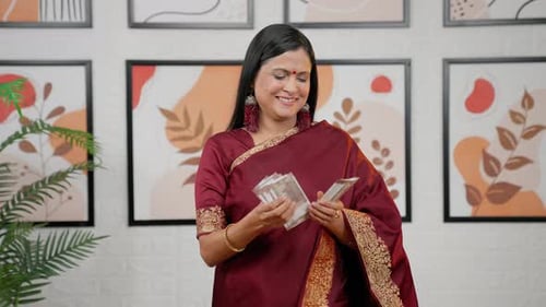 Woman Counts Currency in Home