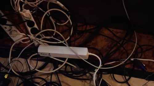 Tangled Cables and a Power Strip That Is Located Underneath a Desk for Better Workspace Organization