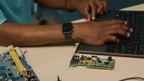 Zoomer Using Laptop when Assembling Computer Details in Home Workshop